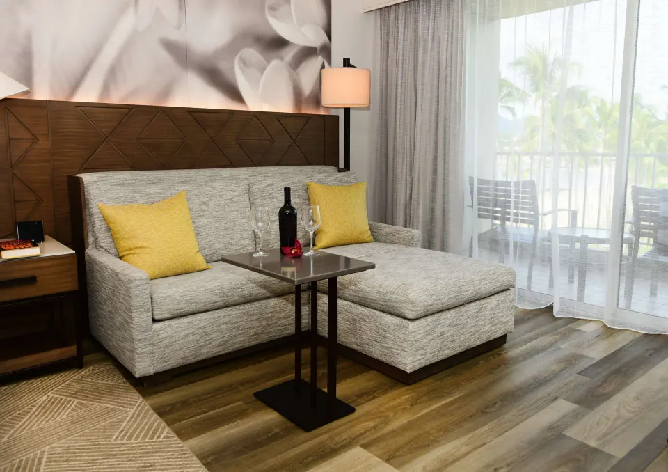 Ocean view room sitting area with chaise and balcony at The Royal Sonesta Kaua'i Resort Lihue.