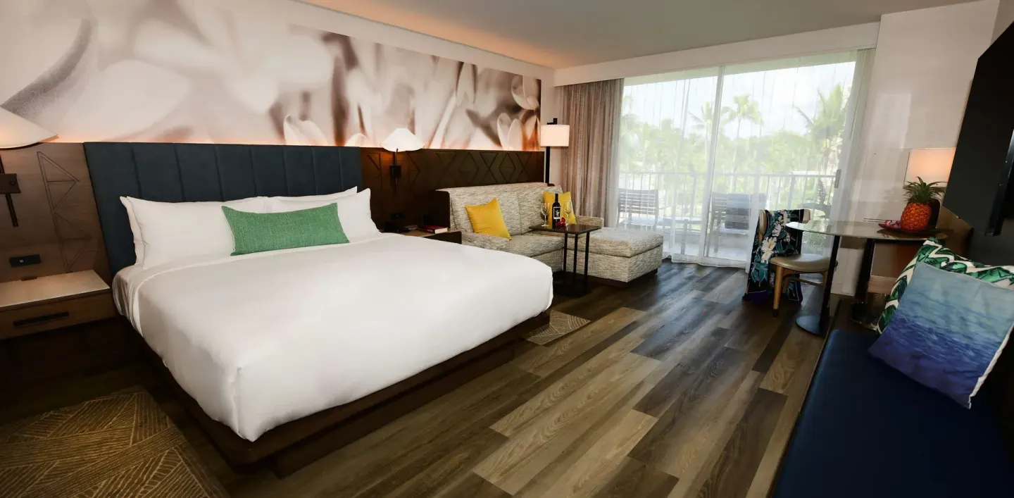 Pool View king guest room with seating and balcony at The Royal Sonesta Kaua'i Resort Lihue.