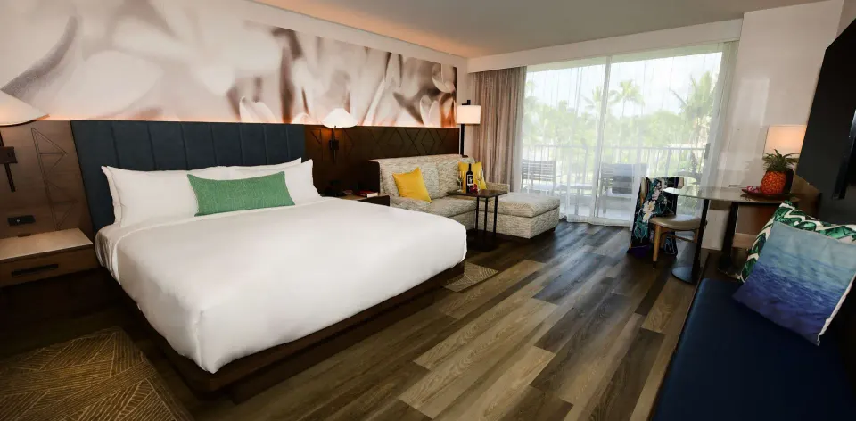 Pool View king guest room with seating and balcony at The Royal Sonesta Kaua'i Resort Lihue.