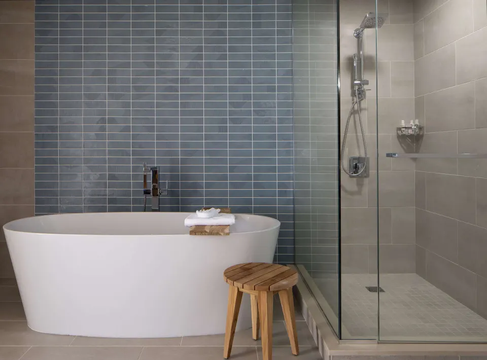 Suite bathroom with freestanding tub and glass shower at The Royal Sonesta Kaua'i Resort Lihue.