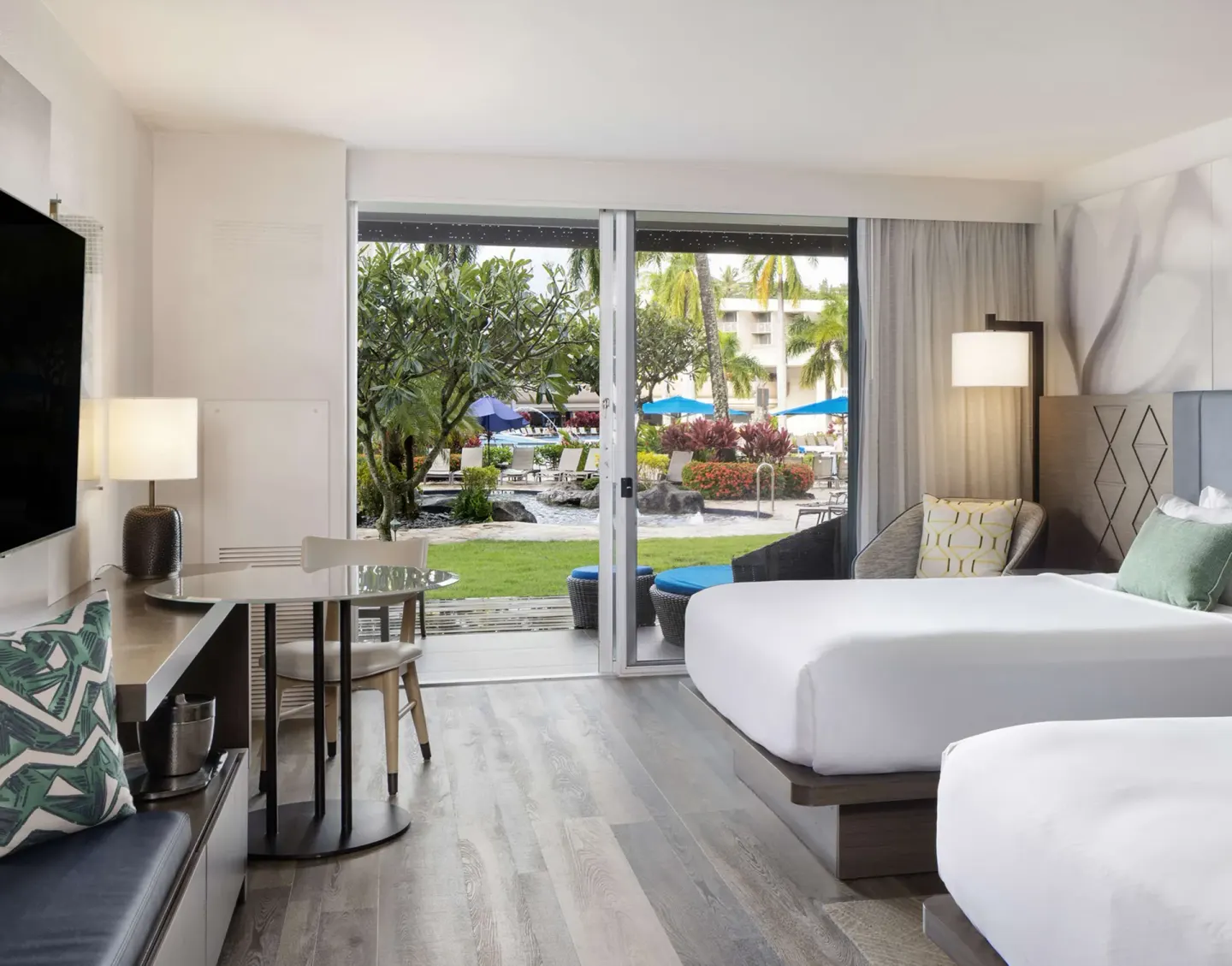 Two Queens Deluxe Ground Floor Lanai guest room at The Royal Sonesta Kaua'i Resort Lihue with garden patio view.