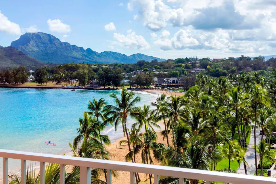 Balcony ocean view over palms and beach at The Royal Sonesta Kaua'i Resort Lihue.