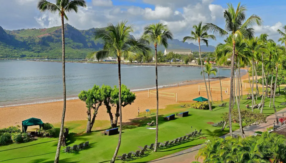 Ocean view with beach, palms, and mountains from The Royal Sonesta Kaua'i Resort Lihue.