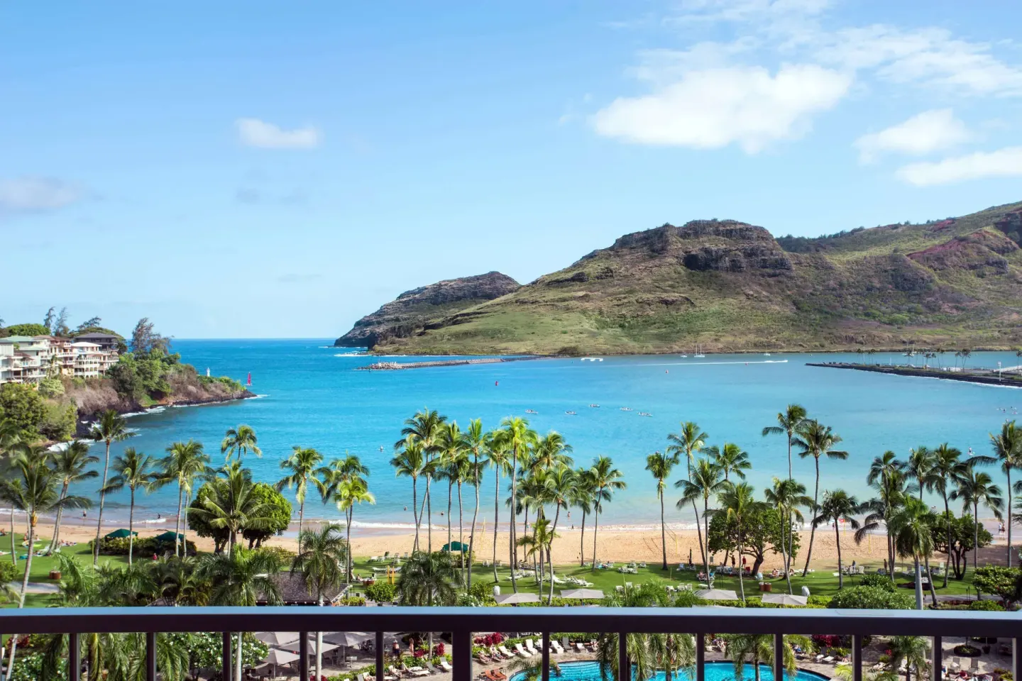Balcony view of bay, beach, palms, and mountains from The Royal Sonesta Kaua'i Resort Lihue.