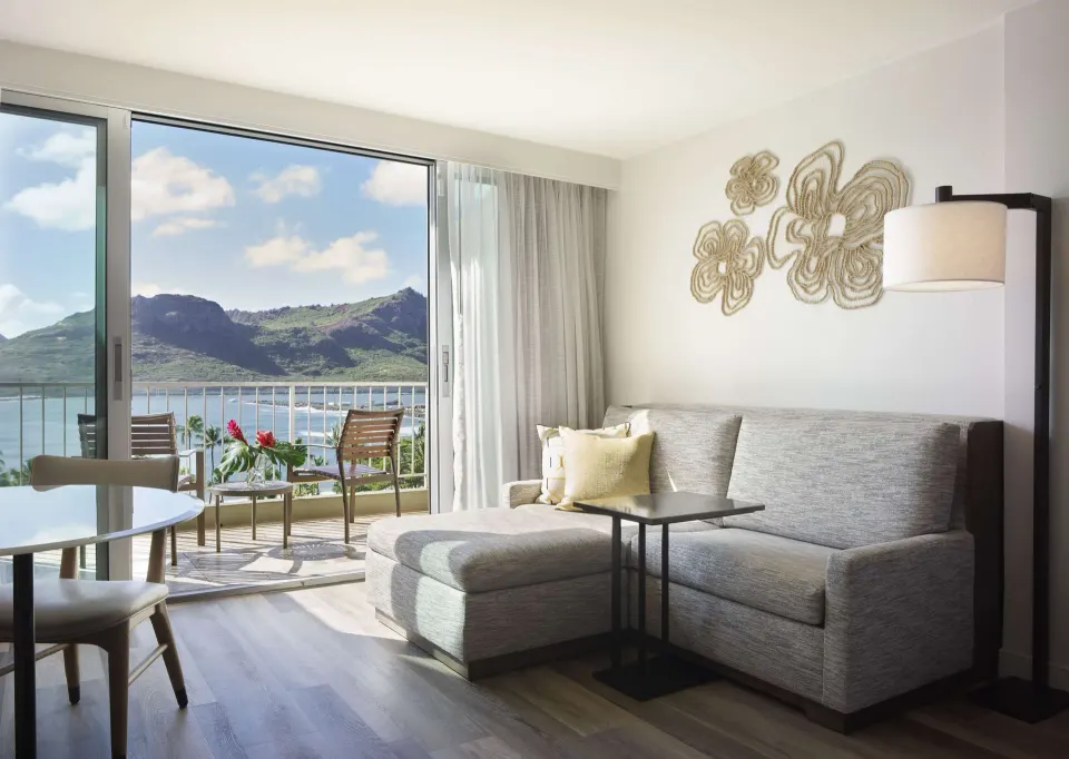 Ocean-view sitting area and balcony in a two-queen room at The Royal Sonesta Kaua'i Resort Lihue.
