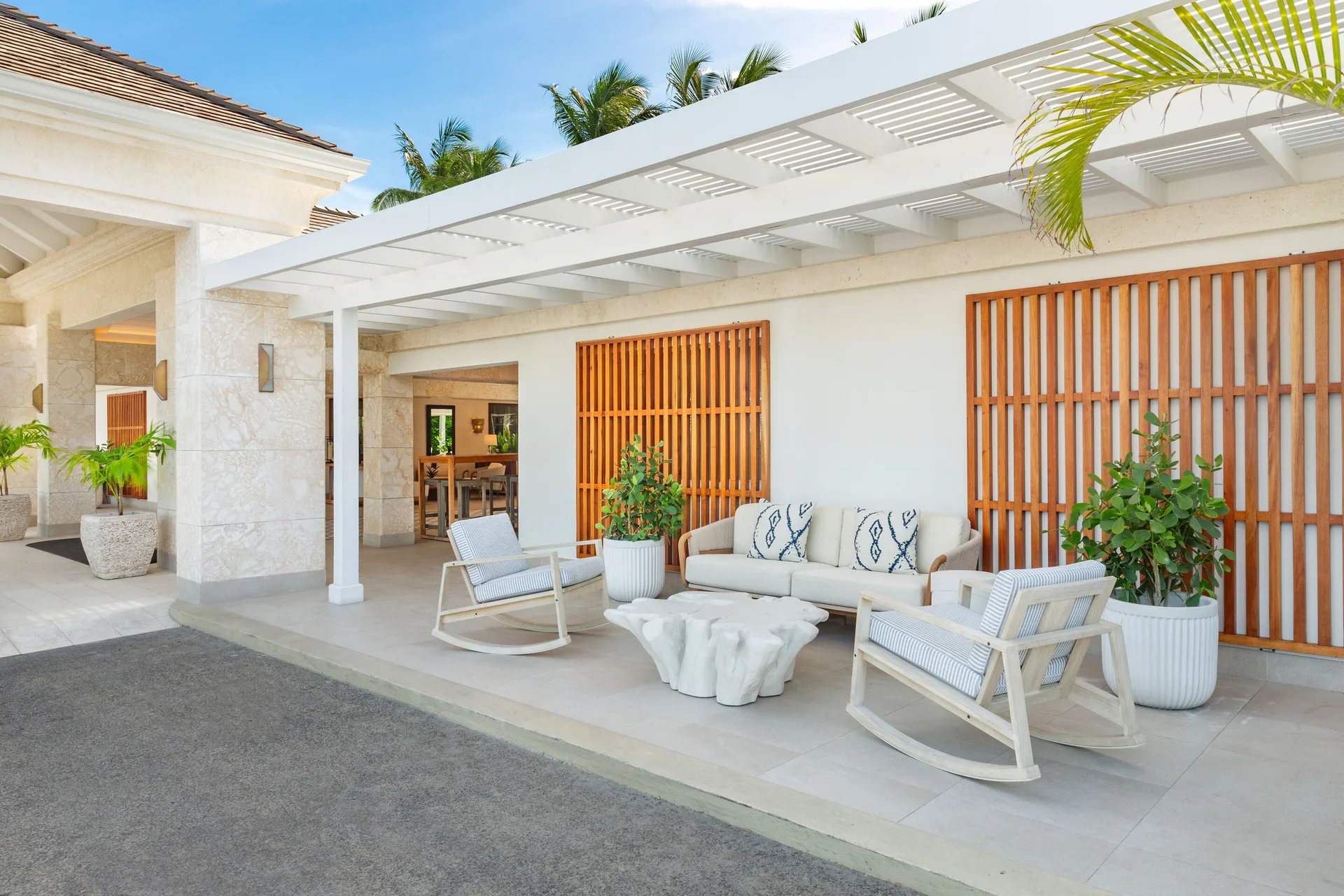 Covered entrance seating with rocking chairs at The Sands at Grace Bay.