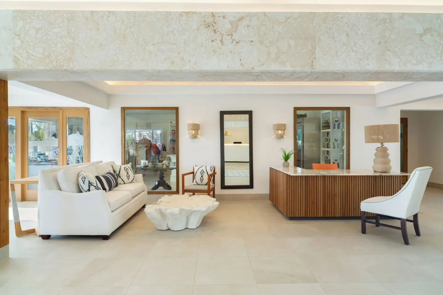 Lobby seating area with reception desk and sofa at The Sands at Grace Bay.