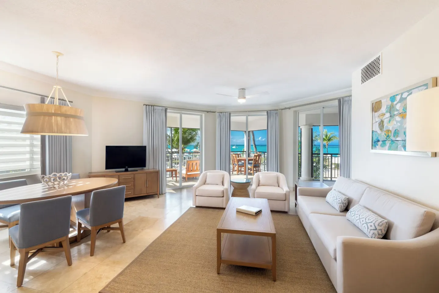 Ocean-facing living and dining room at The Sands at Grace Bay.