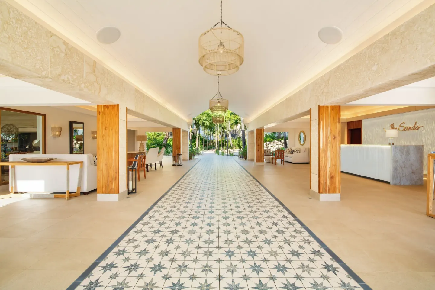 Open-air lobby walkway with patterned tile floor at The Sands at Grace Bay.