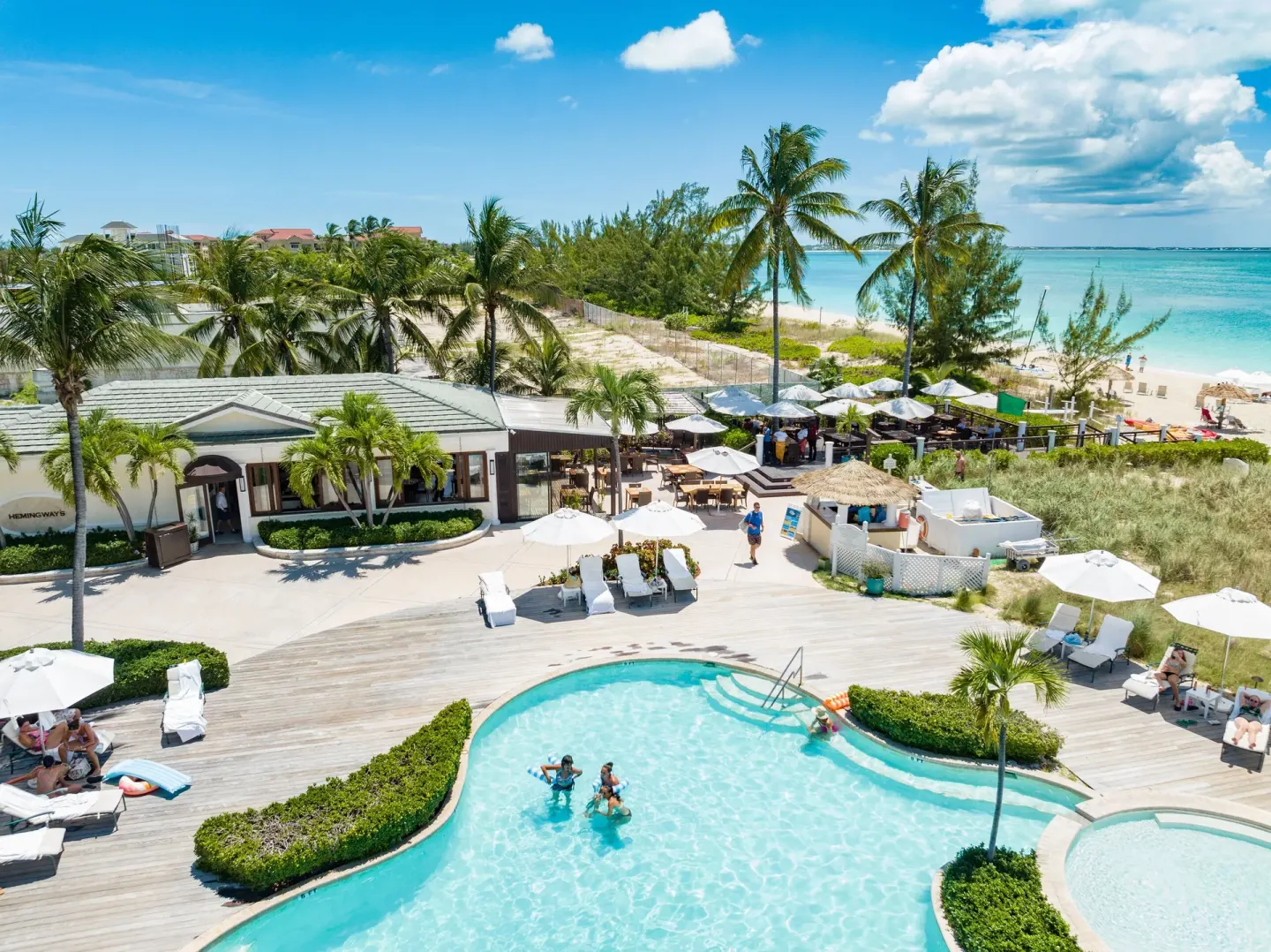 Aerial view of the pool deck beside Grace Bay beach at The Sands at Grace Bay.