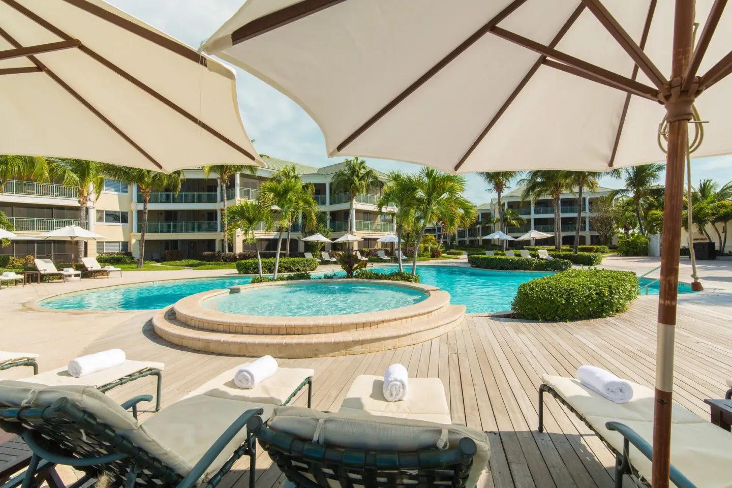 Pool loungers under umbrellas at The Sands at Grace Bay.