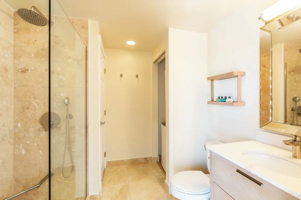 Junior Suite Garden View bathroom with glass shower and vanity at The Sands at Grace Bay.