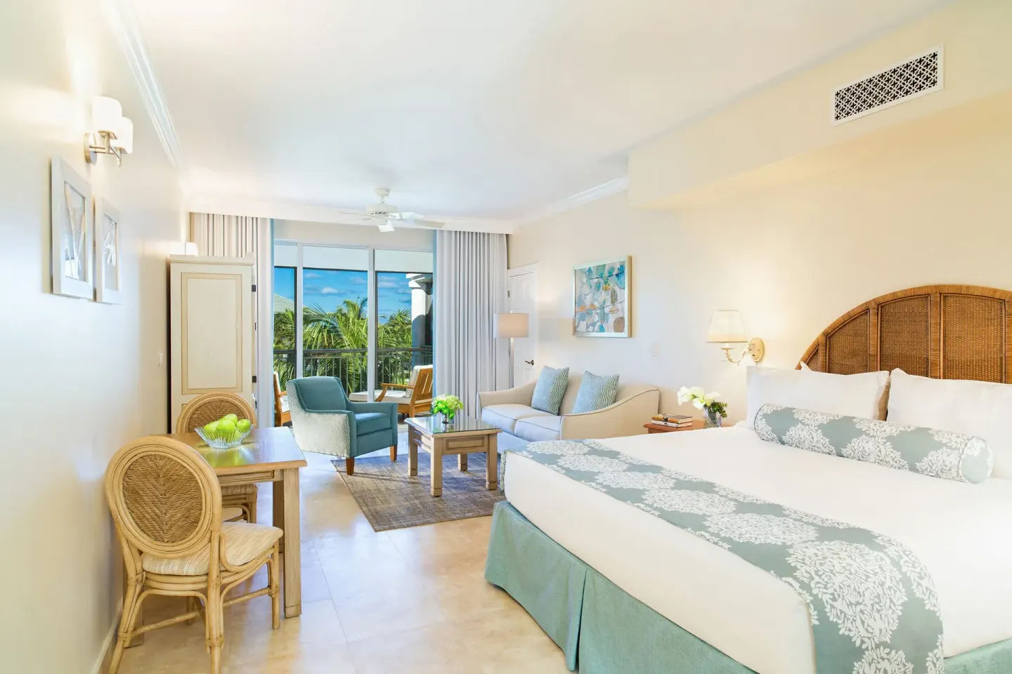 Junior Suite Ocean View with king bed and sitting area at The Sands at Grace Bay.