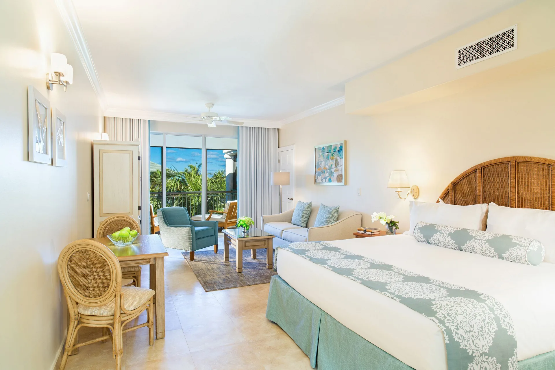 Junior Suite Ocean View with king bed and sitting area at The Sands at Grace Bay.
