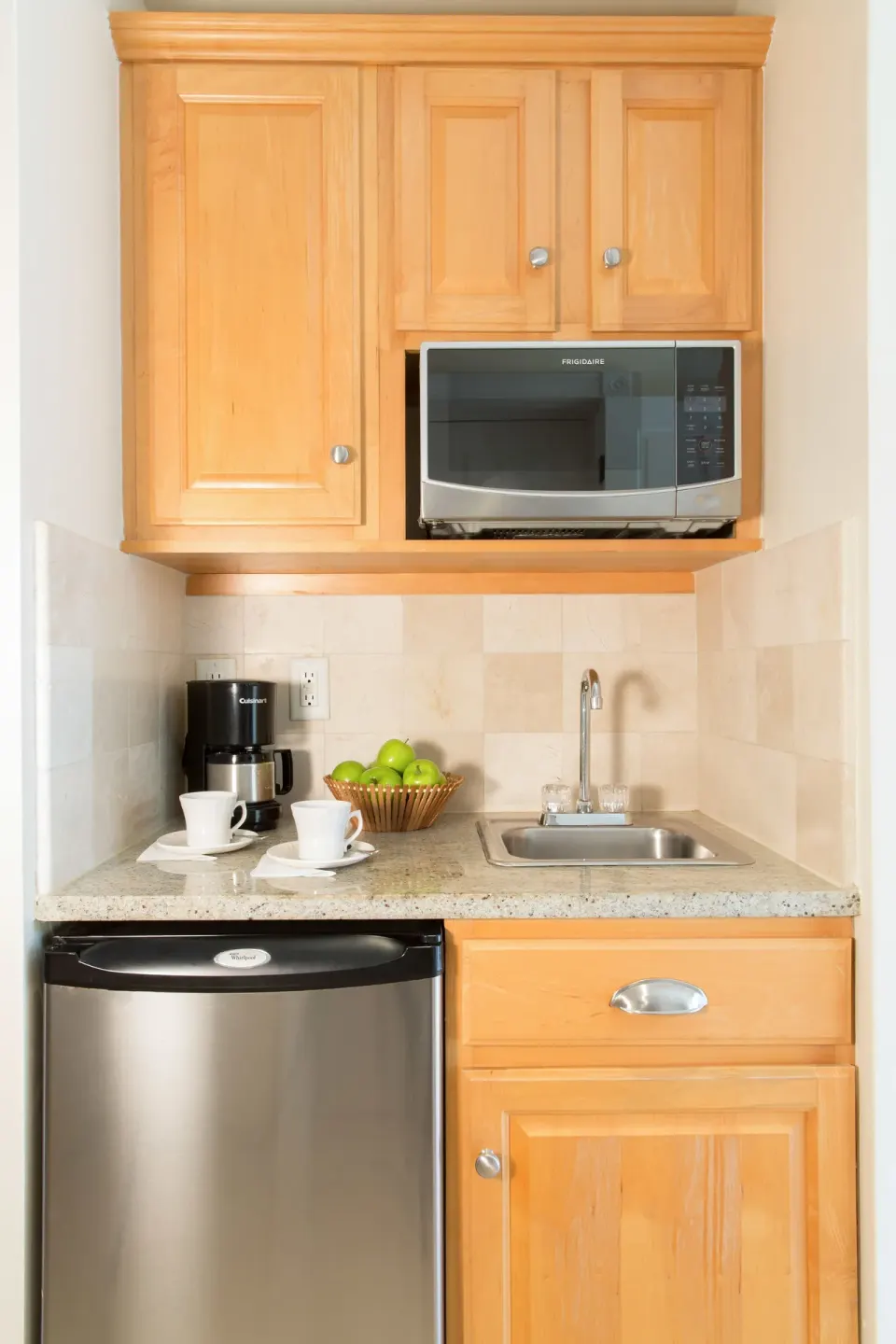 Junior Suite Ocean View kitchenette with microwave, mini fridge and sink at The Sands at Grace Bay.