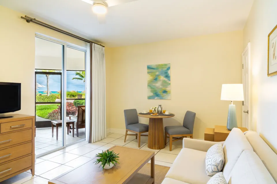 Junior Suite living area with patio and ocean beyond at The Sands at Grace Bay.