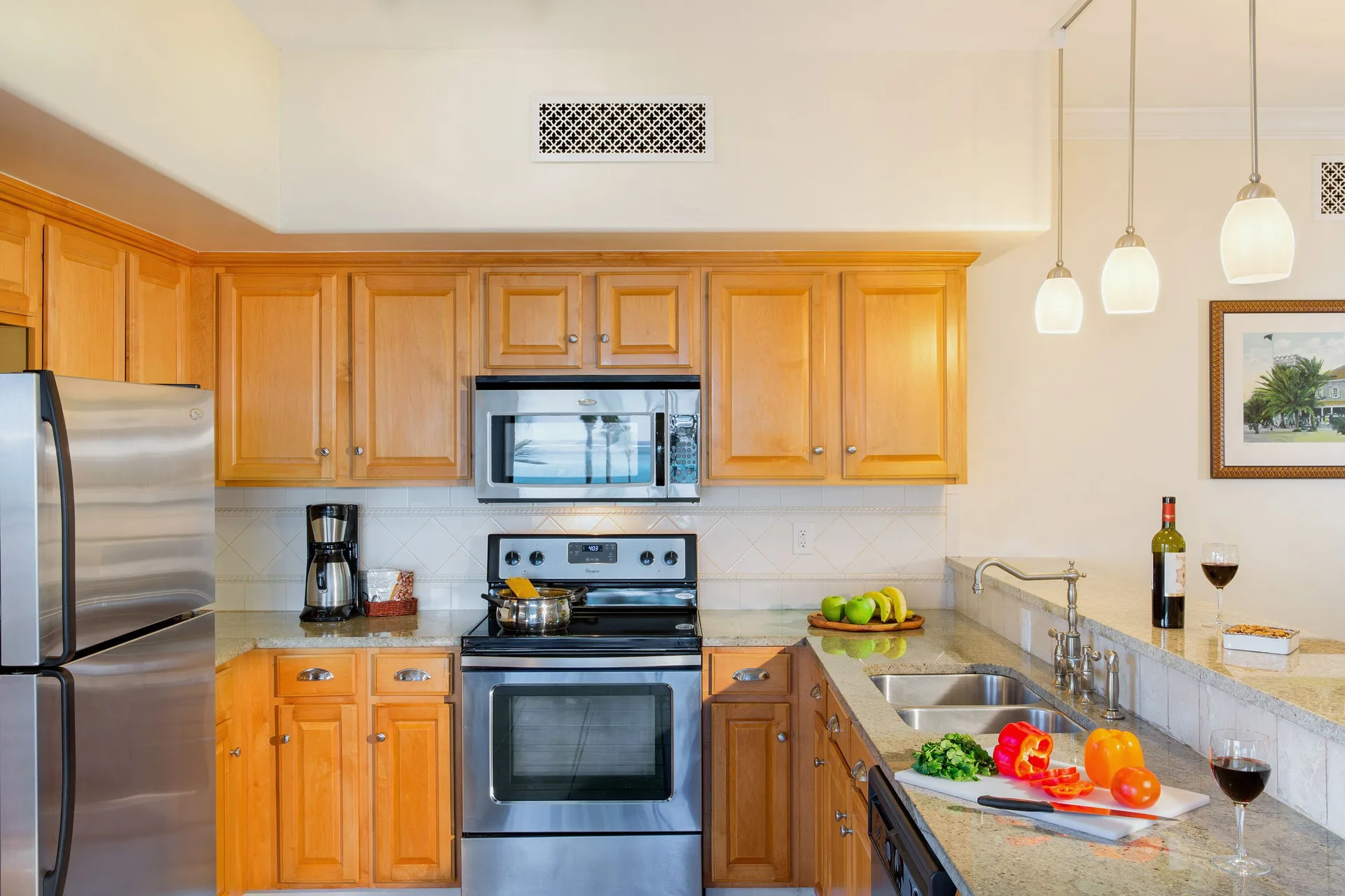 One-bedroom garden view suite kitchen with wood cabinets at The Sands at Grace Bay.