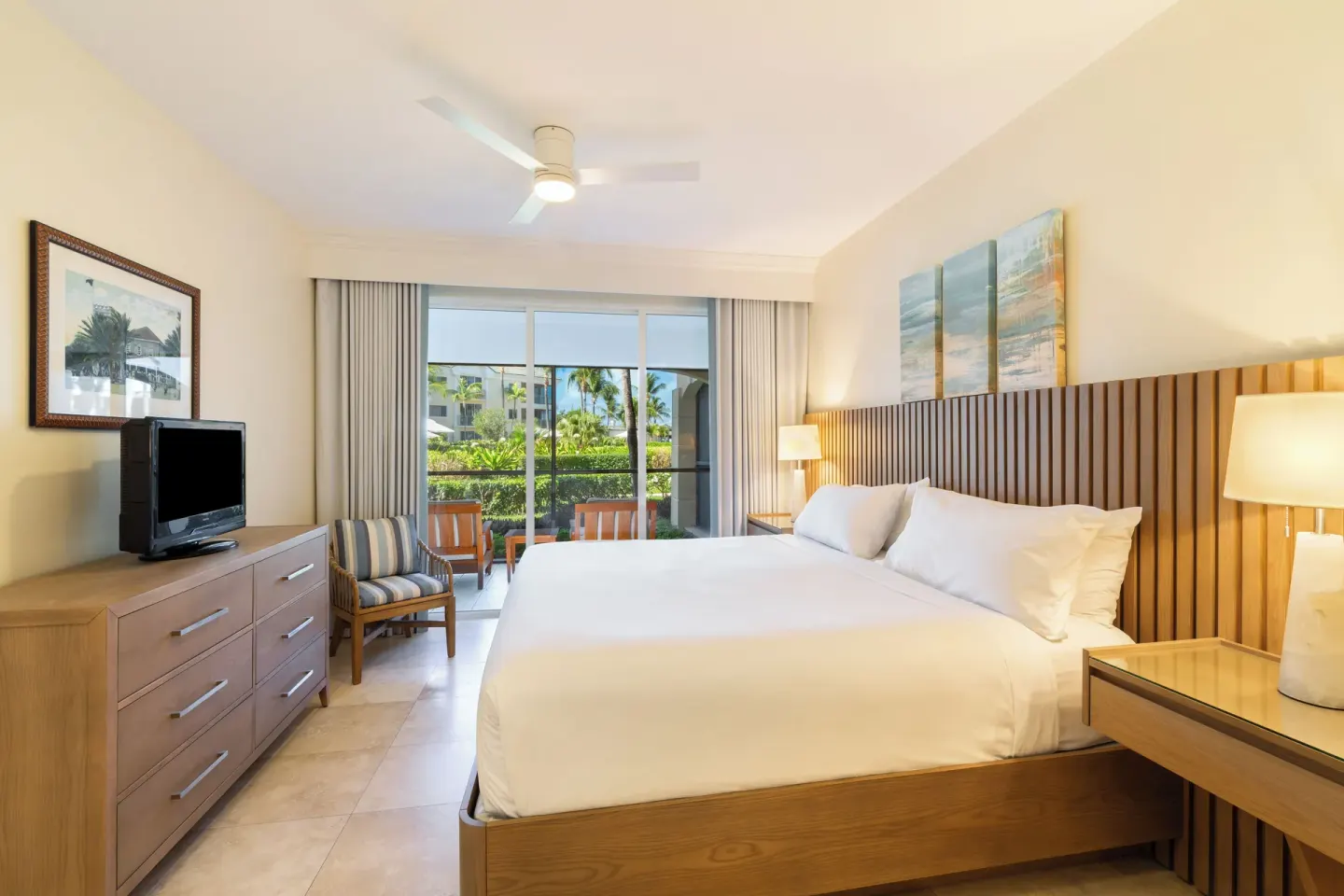 One-bedroom garden view suite bedroom with king bed at The Sands at Grace Bay.