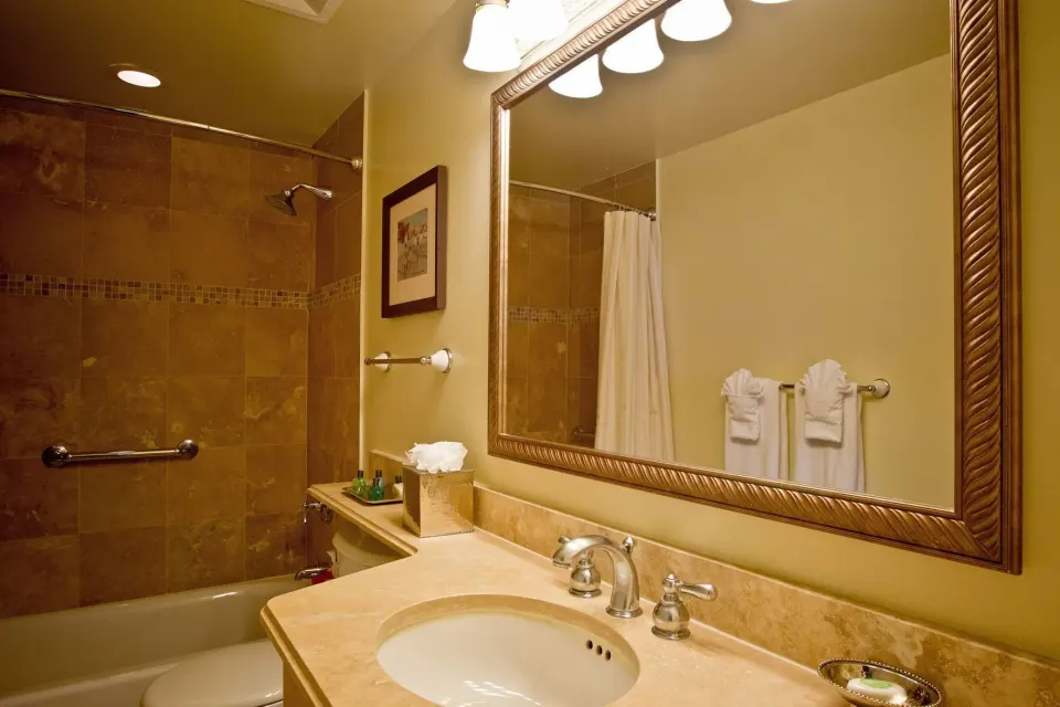 Two Bedroom Suite bathroom with vanity and tub shower at The Sands at Grace Bay.