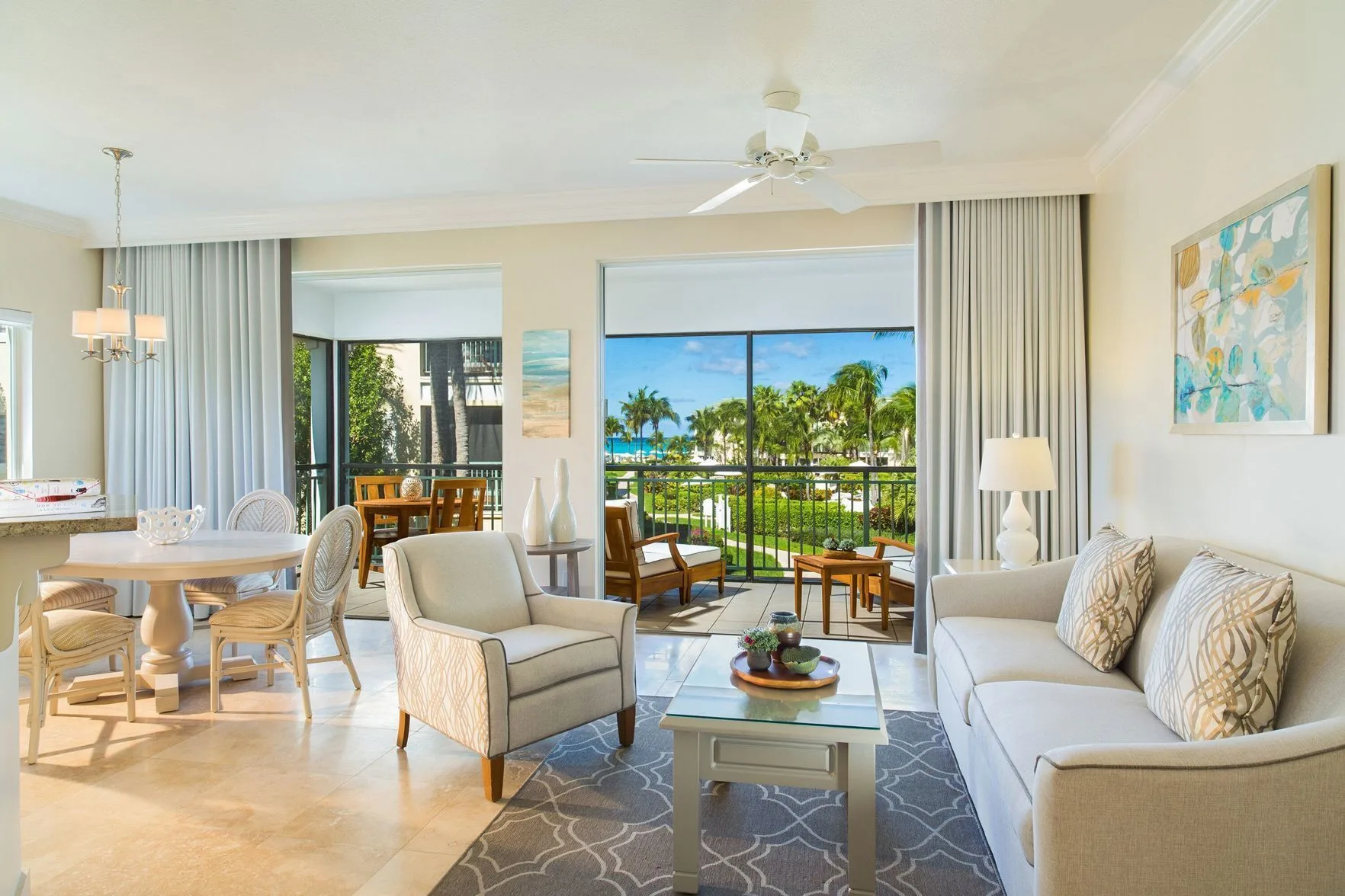 Two Bedroom Suite living and dining area with balcony at The Sands at Grace Bay.