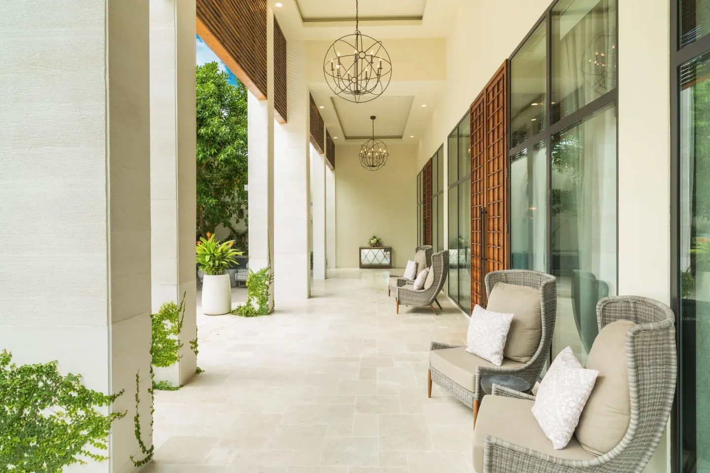 Covered resort corridor with wicker chairs at The Shore Club Turks and Caicos.