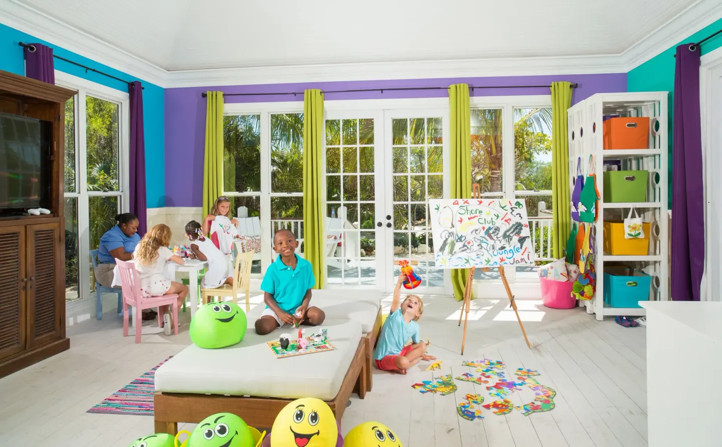 Children play and paint in a bright kids club room at The Shore Club Turks and Caicos.