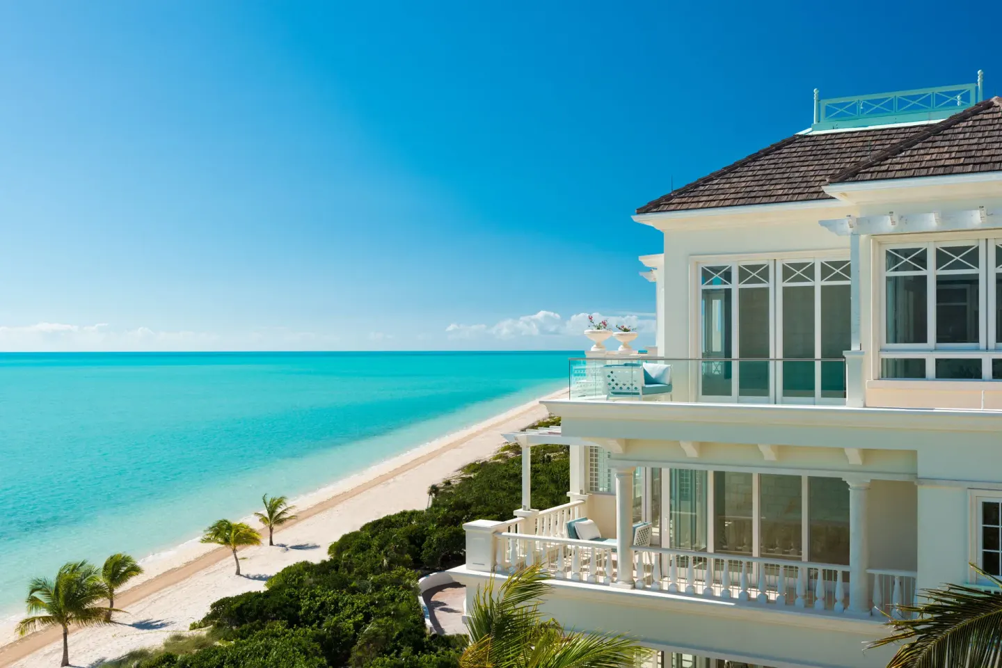 Oceanfront building with balconies beside the beach at The Shore Club Turks and Caicos.