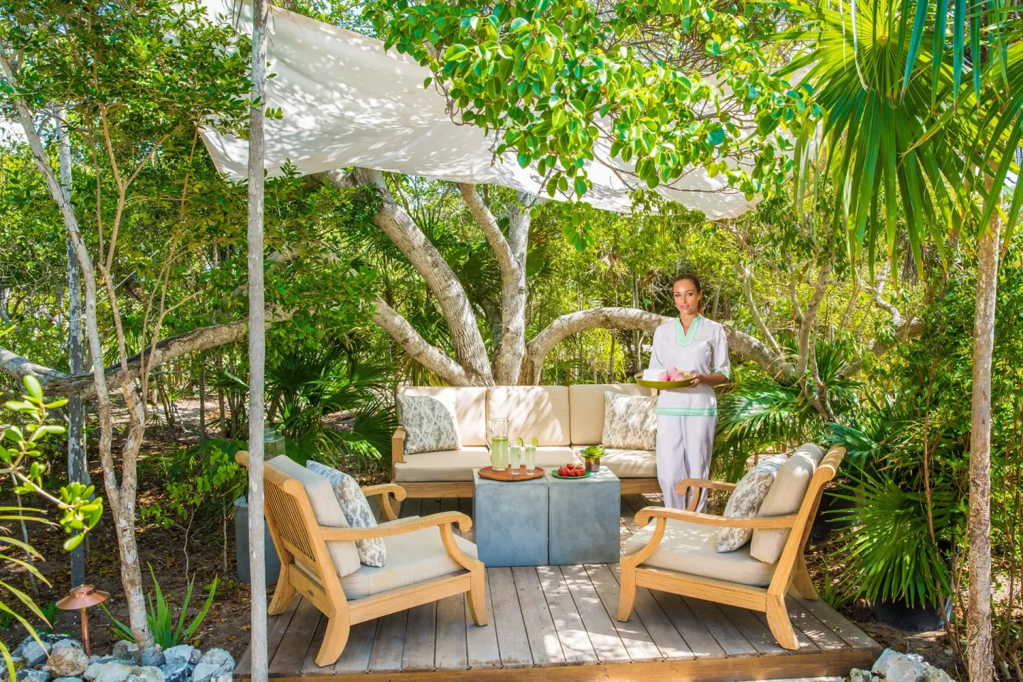 Shaded garden seating with refreshments at The Shore Club Turks and Caicos.