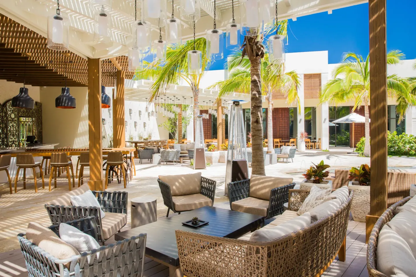 Shaded courtyard lounge and bar seating at The Shore Club Turks and Caicos.