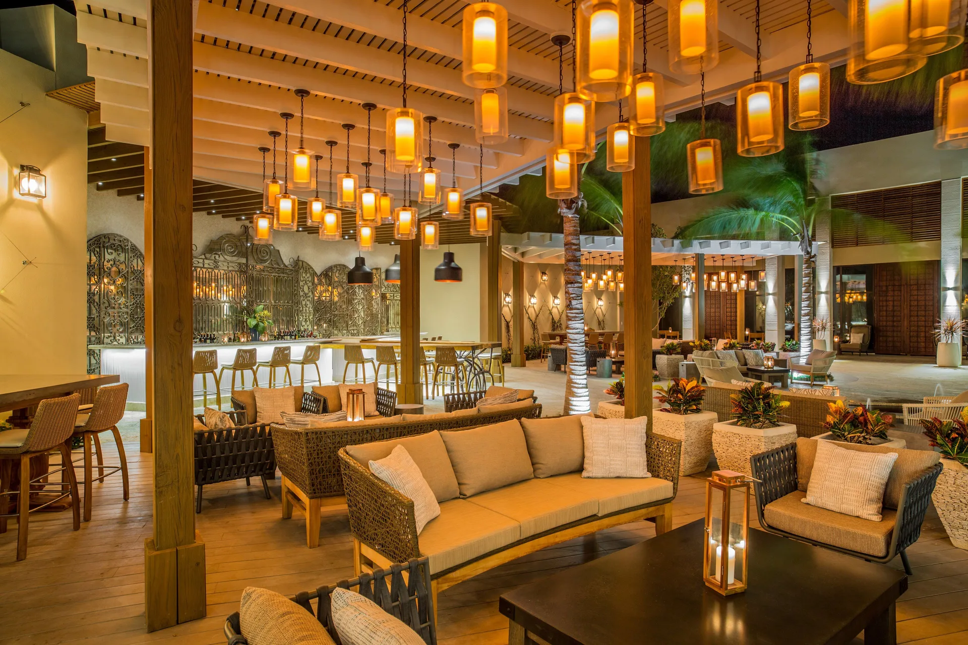 A covered lounge and bar with glowing lanterns at The Shore Club Turks and Caicos.