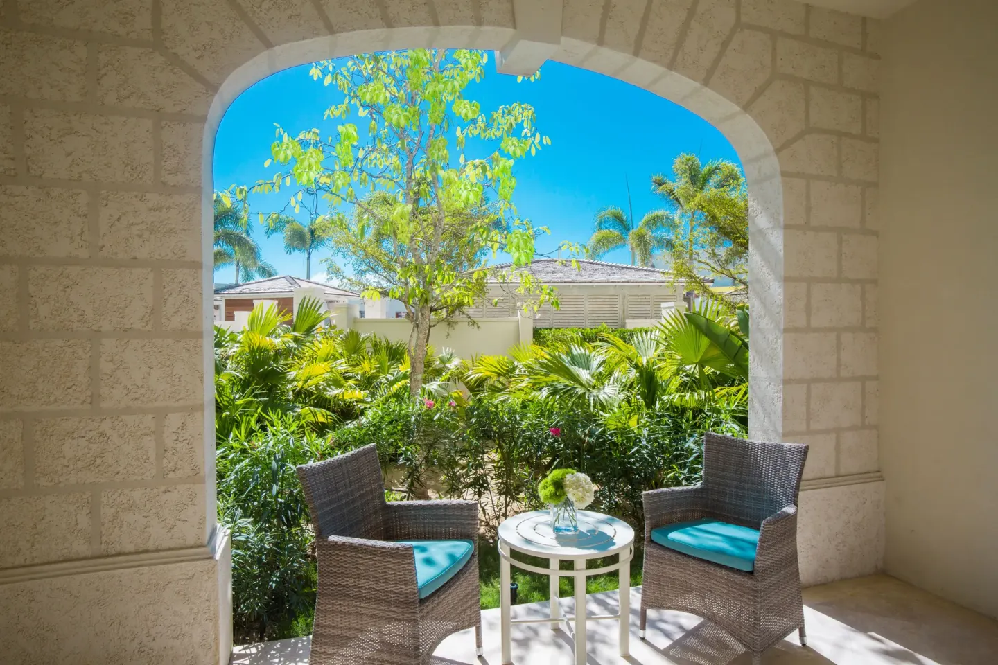 Junior Suite Garden View terrace framed by a stone arch at The Shore Club Turks and Caicos.