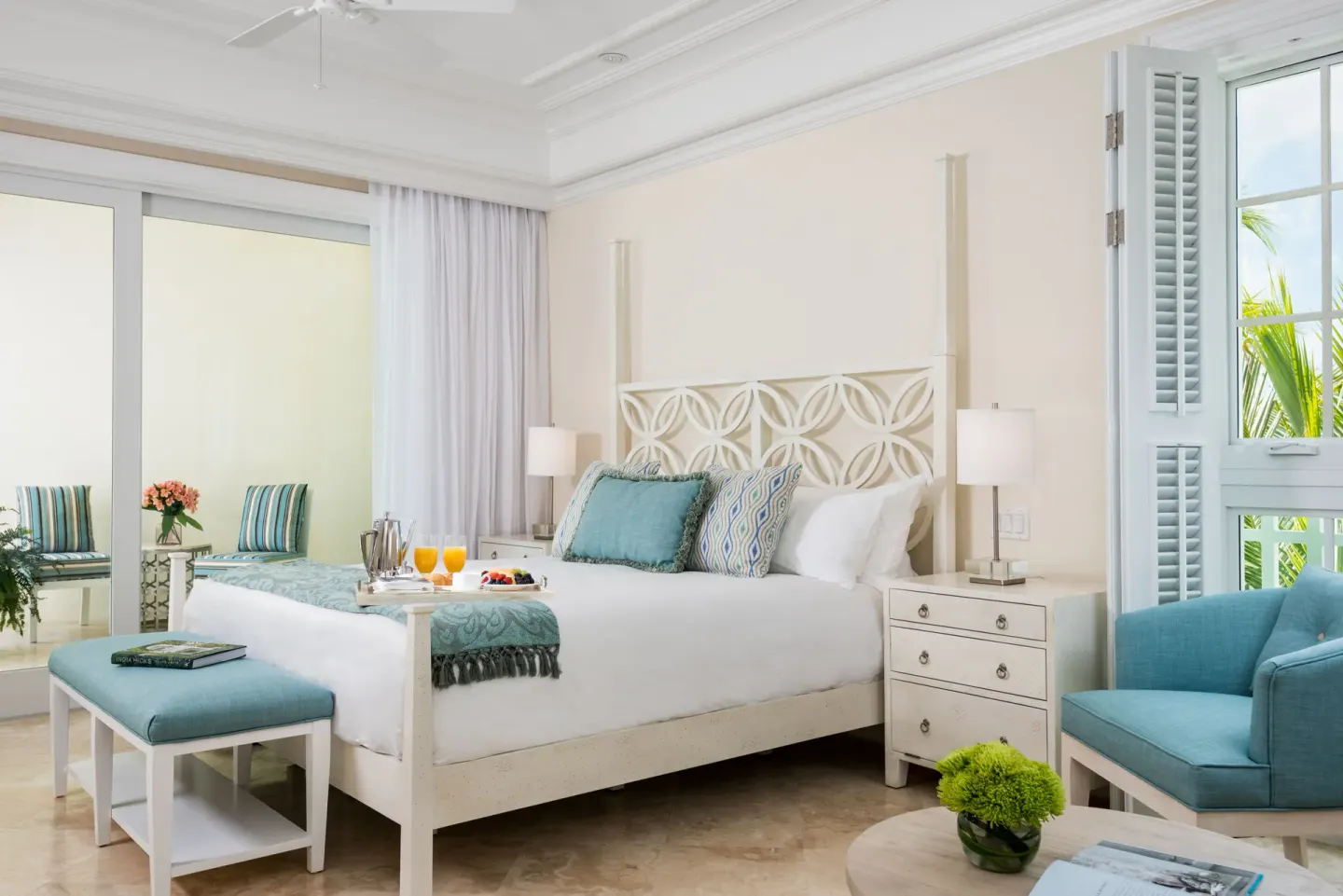 Junior Suite Garden View bedroom with king bed and seating at The Shore Club Turks and Caicos.