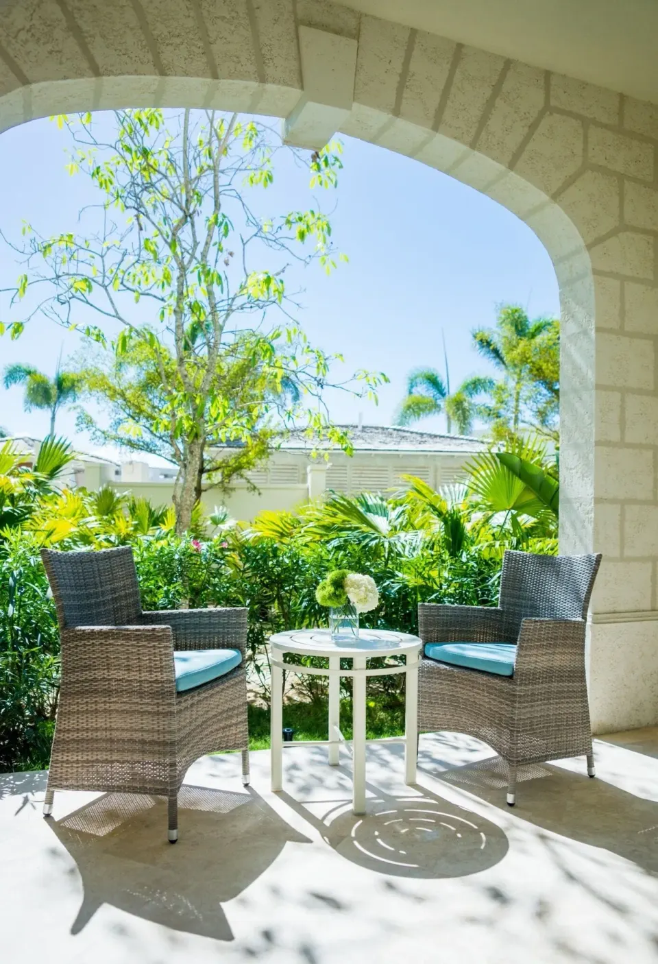 Junior Suite Garden View patio with wicker chairs at The Shore Club Turks and Caicos.