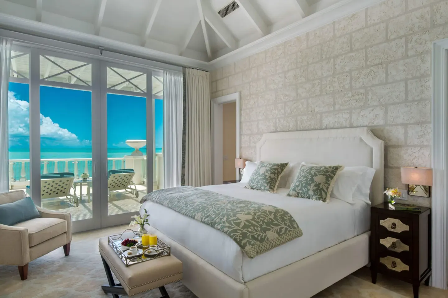 Junior Suite Pool View king bed and balcony at The Shore Club Turks and Caicos.