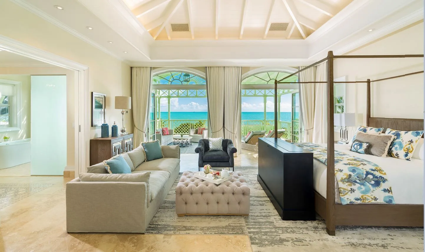 Luxury Villa bedroom and sitting area at The Shore Club Turks and Caicos with a four-poster king bed.