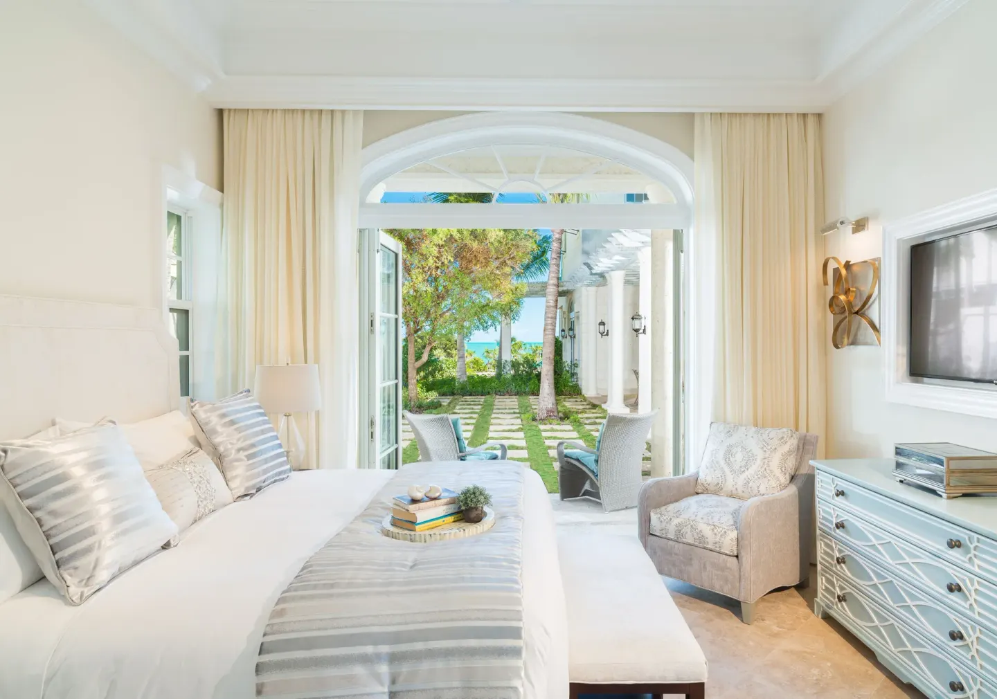 King bedroom in a Luxury Villa at The Shore Club Turks and Caicos opening to a garden patio and ocean view.