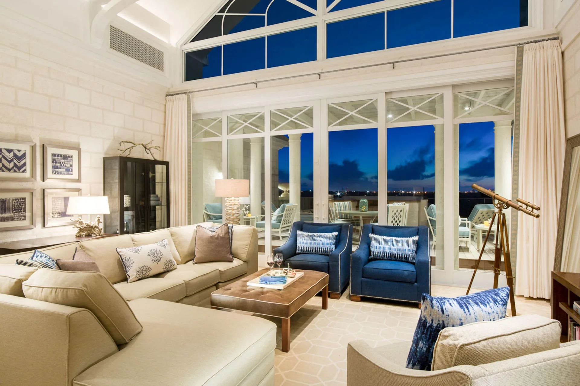 One Bedroom Penthouse at The Shore Club Turks and Caicos with evening-lit living room, modern design, and Long Bay Beach ambiance.