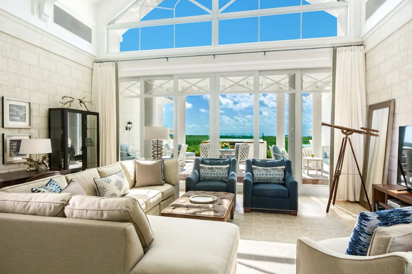 Penthouse lounge with terrace seating beyond glass doors at The Shore Club Turks and Caicos.