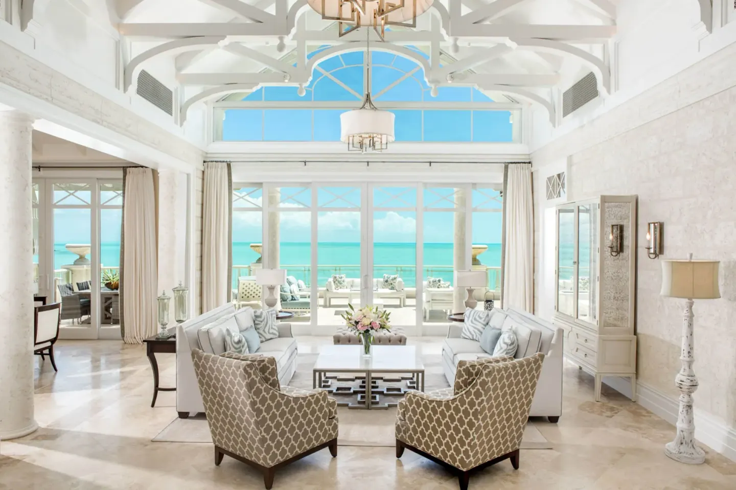 Penthouse living room with vaulted ceiling and sea view at The Shore Club Turks and Caicos.