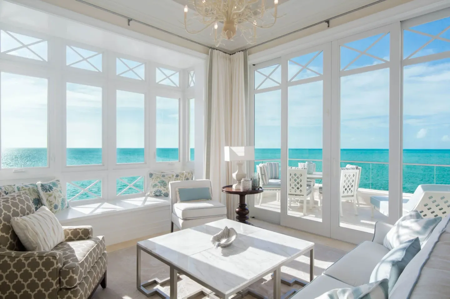 Penthouse lounge with wraparound windows and balcony at The Shore Club Turks and Caicos.