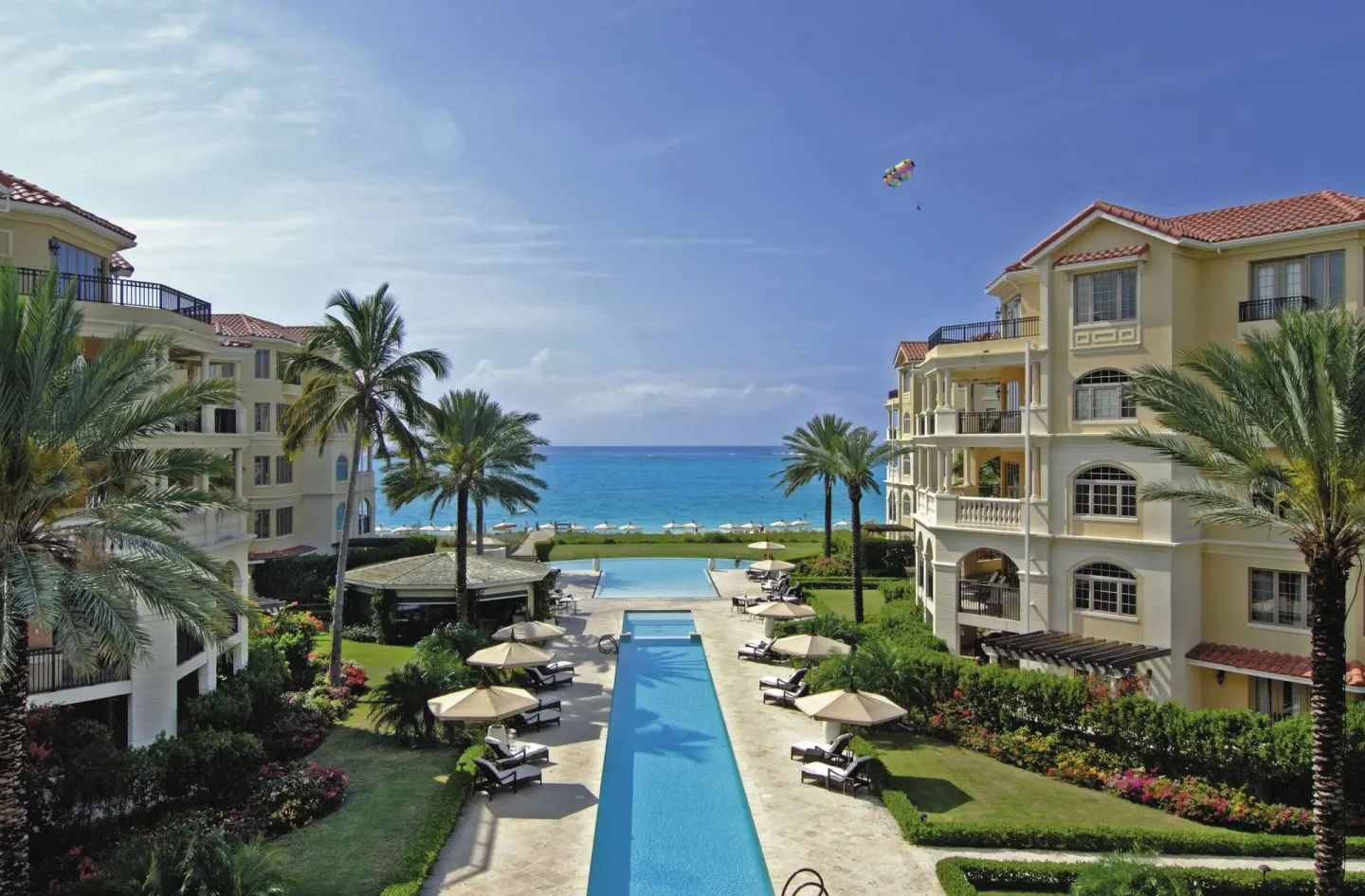 Oceanfront pool courtyard between resort buildings at The Somerset on Grace Bay.