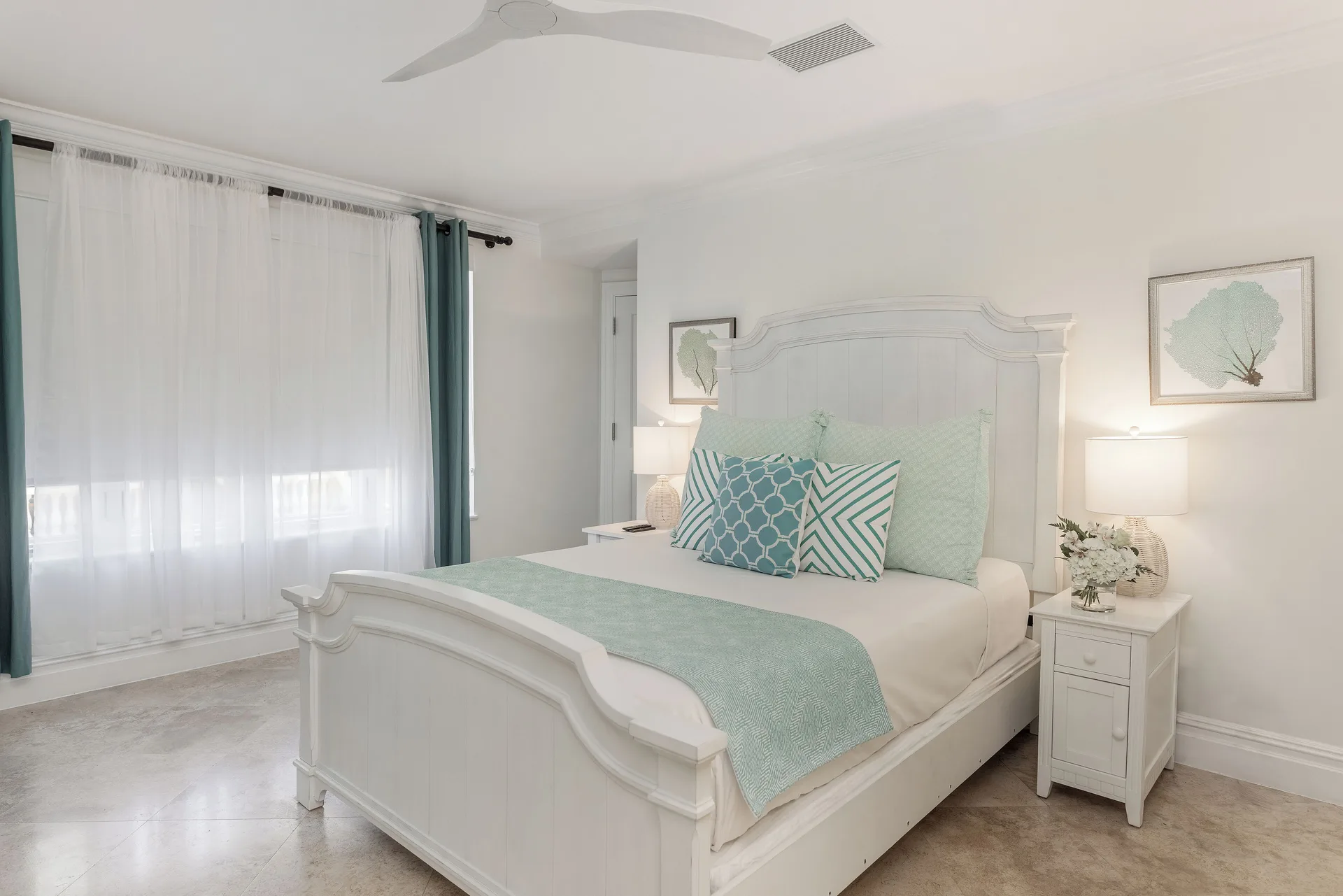 Villa 1 Bedroom Pool View white king bed and teal curtains at The Somerset on Grace Bay.
