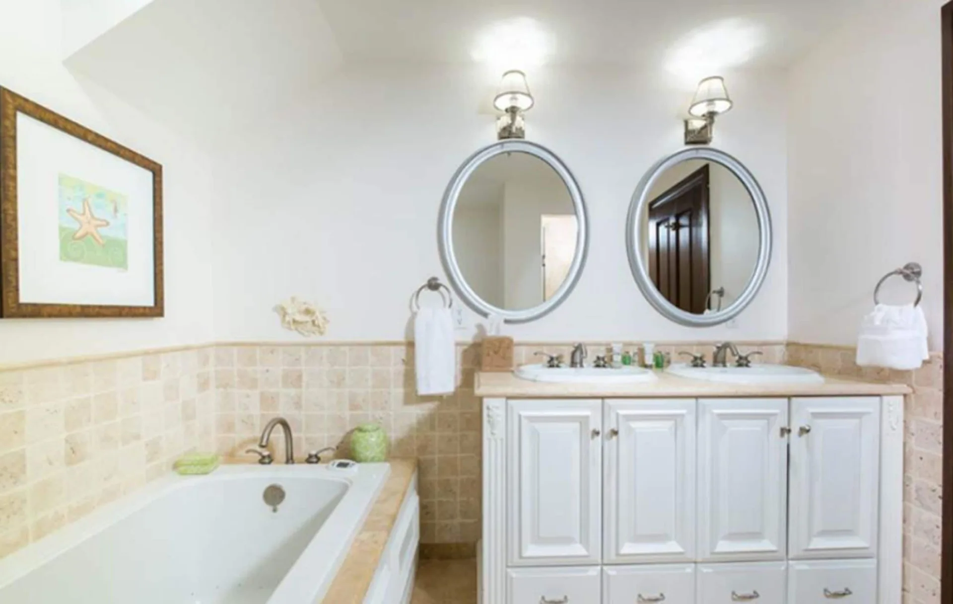 Two-bedroom pool view villa bathroom with tub and double vanity at The Somerset on Grace Bay.