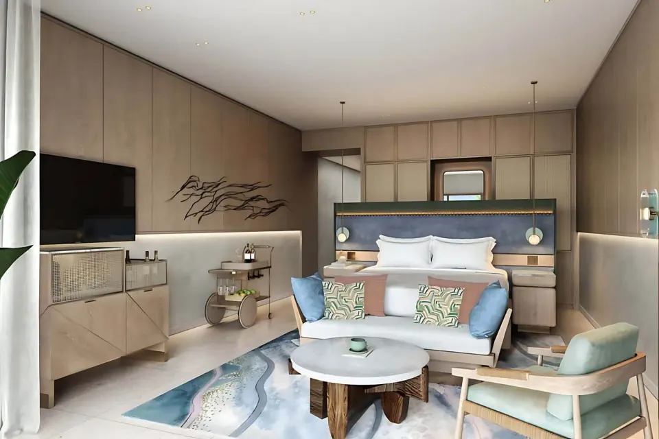 Deluxe Rooftop Room with king bed and seating at The St Regis Cap Cana Resort.