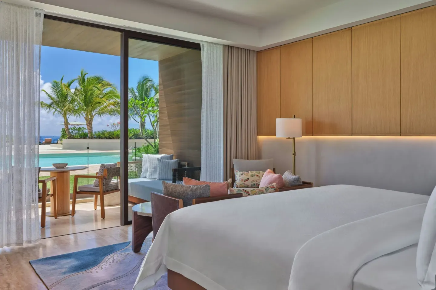 Deluxe Room with king bed and poolside balcony at The St Regis Cap Cana Resort.