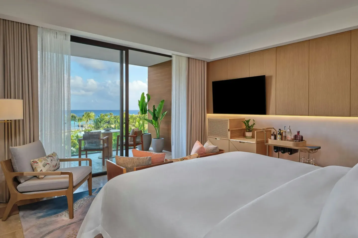 Grand Room king bed with ocean-view balcony at The St Regis Cap Cana Resort.