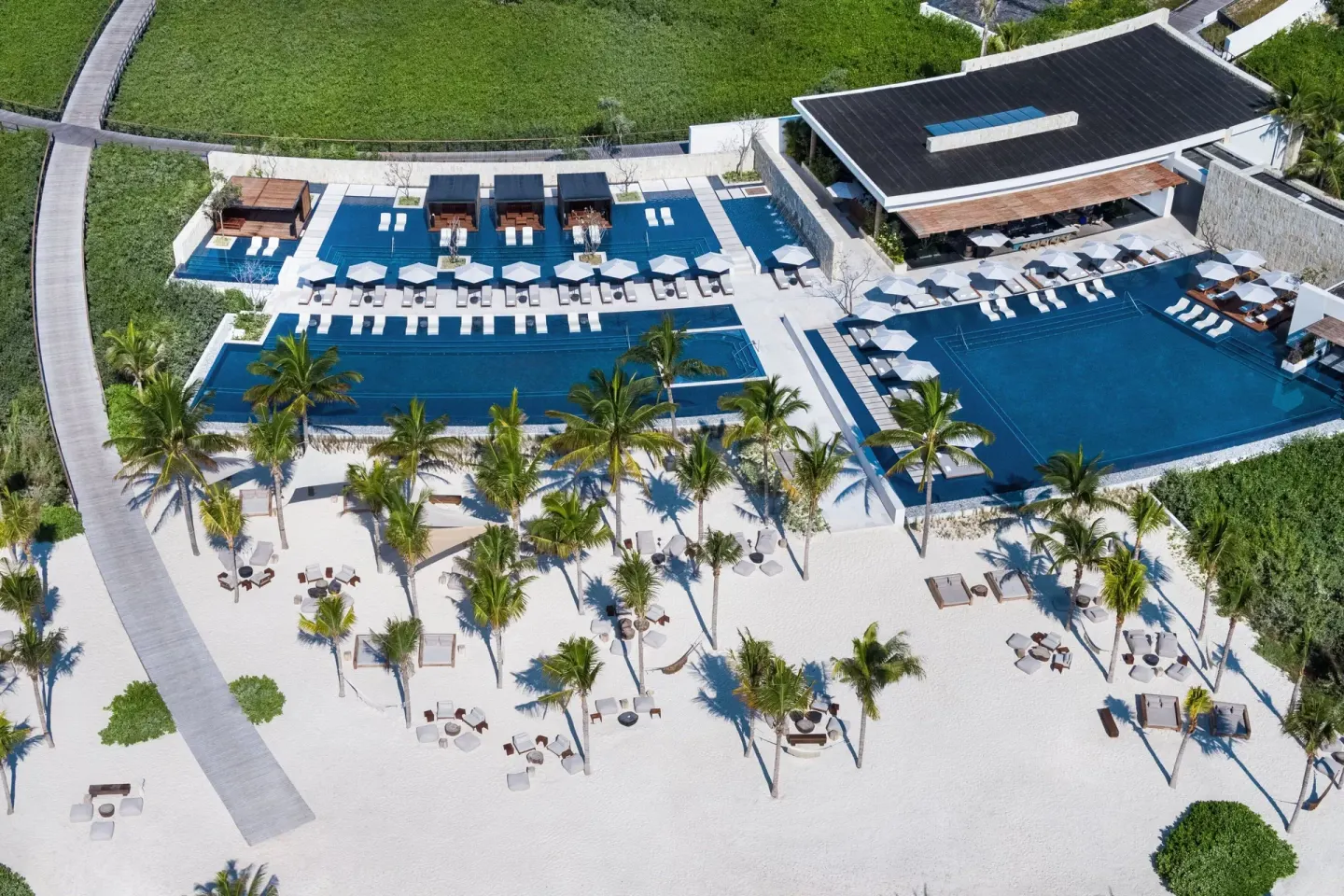 Aerial view of pools, palms, cabanas and sand at The St. Regis Kanai Resort, Riviera Maya.