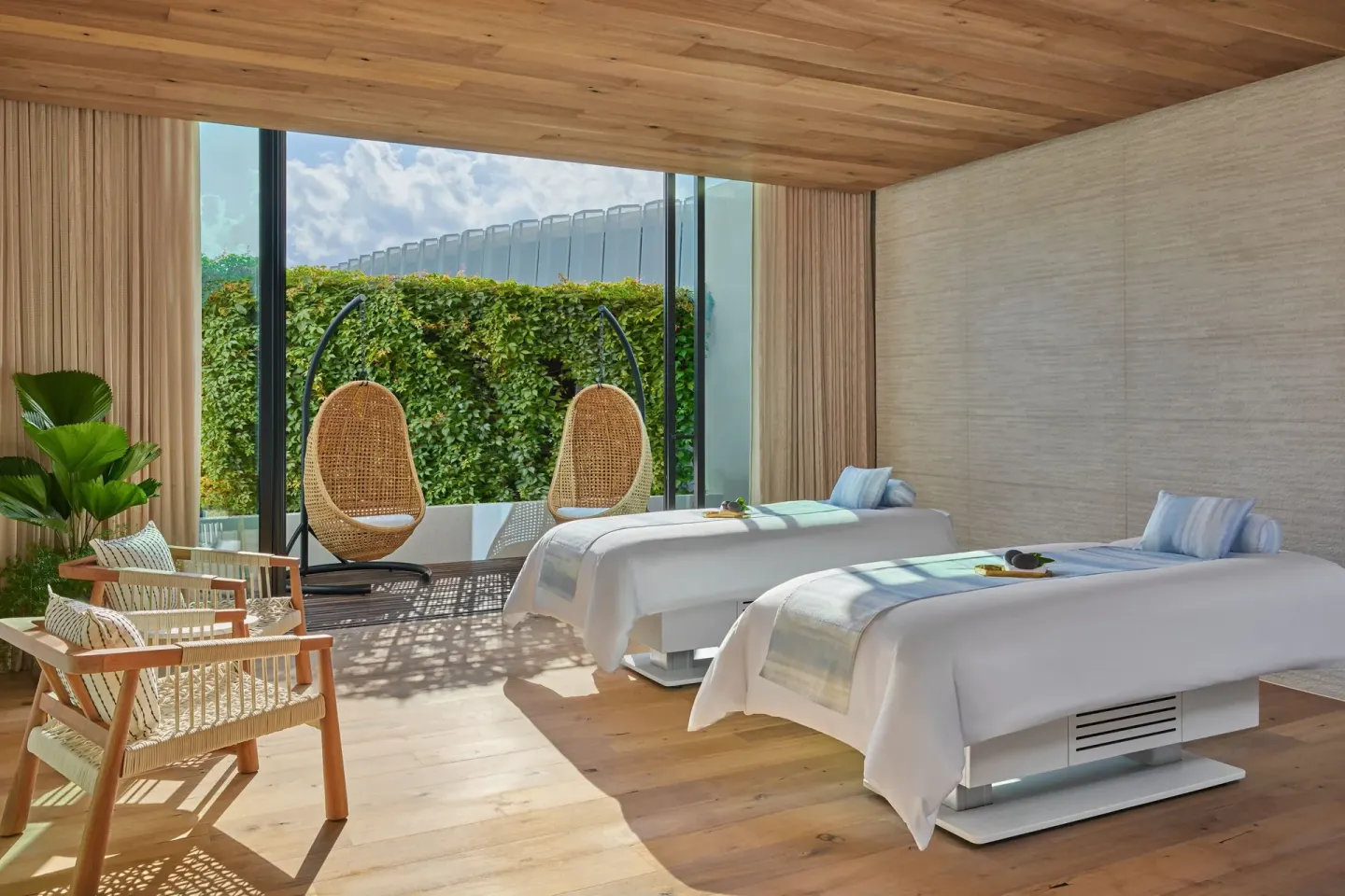 Couples treatment room with two massage tables at The St. Regis Kanai Resort, Riviera Maya.