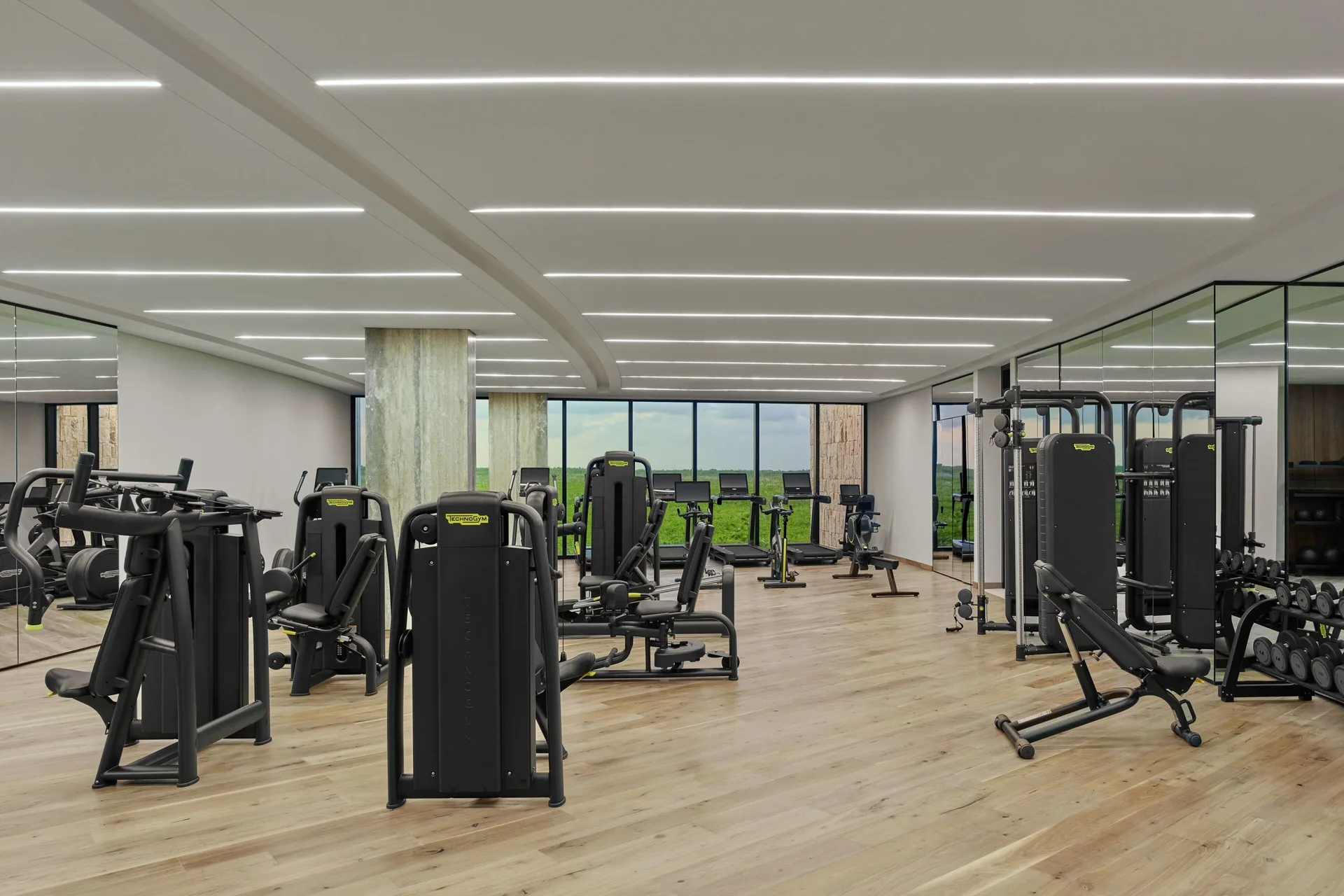 Fitness center with cardio and weight equipment at The St. Regis Kanai Resort, Riviera Maya.