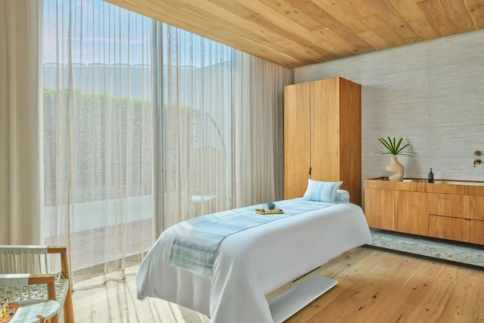 Single spa treatment room with wood cabinetry at The St. Regis Kanai Resort, Riviera Maya.